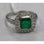 An Art Deco style platinum, emerald and diamond cluster ring, size P.