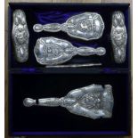 An Edwardian Art Nouveau repousse silver six piece brush and mirror set, by Levi & Salaman,