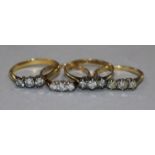 Four 18ct gold and three stone diamond rings.