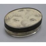 An early 19th century silver oval snuff box, top underside painted with eyes