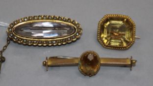 Three early 20th century yellow metal and gem set brooches, including one stamped 9ct and one rock