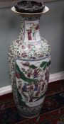 A pair of massive Chinese famille rose baluster vases, each painted to reserves with a procession of