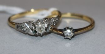 An 18ct gold single stone diamond ring with diamond set shoulders and an 18ct gold and solitaire