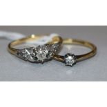 An 18ct gold single stone diamond ring with diamond set shoulders and an 18ct gold and solitaire