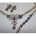 A silver, paste and marcasite demi parure, comprising a necklace, bracelet and pair or earrings.