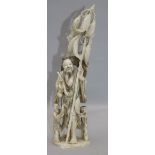 A large Chinese ivory group of a fisherman and two children, first half 20th century, the