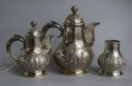 A 20th century Indonesian white metal three piece coffee set.