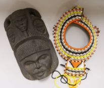 A carved wooden mask and beadwork