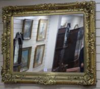 A large gilt gesso picture framed wall mirror, W.118cm