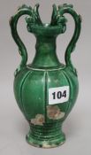 A Chinese green glazed pottery twin handled vase, in Tang style, with dragon head handles and a