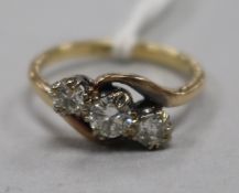 An 18ct gold and three stone diamond ring, size K.