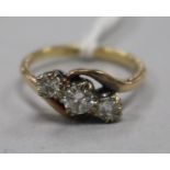 An 18ct gold and three stone diamond ring, size K.