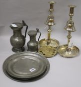 A pair silver plated brass tavern candlesticks, three pewter plates, two measures and a 'Confederate