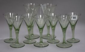 Attributed to James Powell & Sons, circa 1900, a part suite of nine green-tinted trumpet-shaped wine