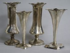 A pair of Edwardian silver spill vases and two smaller similar, loaded, 17.2cm.