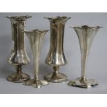 A pair of Edwardian silver spill vases and two smaller similar, loaded, 17.2cm.