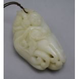 A Chinese white jade carving of a boy clambering on a finger citron, carved in relief with leaves, a
