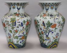 A pair of French faience baluster vases, 19th century, each decorated with birds amid flowers