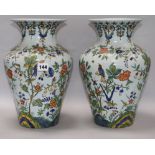 A pair of French faience baluster vases, 19th century, each decorated with birds amid flowers