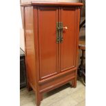 A Chinese red lacquer round corner cabinet, W.68cm