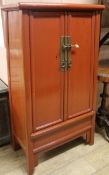 A Chinese red lacquer round corner cabinet, W.68cm