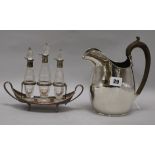 A silver plated jug and a cruet set
