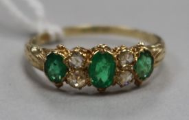 A 15ct gold, emerald and diamond seven stone ring, size O.