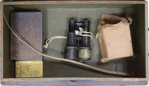 A military tin containing field binoculars and other militariaProvenance- Commander Attenborough