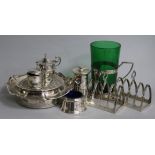 Assorted silver including two toastracks, three cruets, pepper mill, cup holder and a coaster.