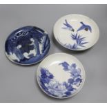 Three Nabeshima style blue and white dishes, figural dish diameter 21cm