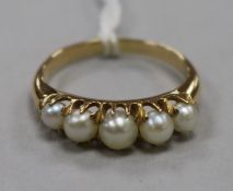 A gold and cultured pearl half hoop ring, set with five graduated cultured pearls, size N.