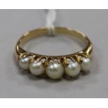 A gold and cultured pearl half hoop ring, set with five graduated cultured pearls, size N.