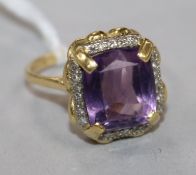 An 18ct gold, amethyst and diamond set dress ring, size M.