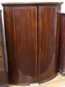 A George III inlaid mahogany bow front hanging corner cupboard W.80cm