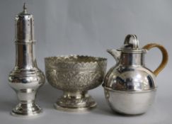 An Indian white metal embossed footed bowl, a plated Guernsey cream jug and a plated sugar caster