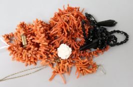 Two coral necklaces, a pair of coral earrings and two other items.
