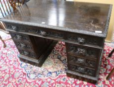 A late Victorian oak pedestal desk W.122cm