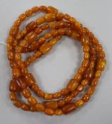 A long single strand amber necklace, with oval and barrel shaped beads, gross weight 192 grams,