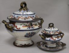 A Staffordshire pottery soup tureen and cover and another tureen and cover