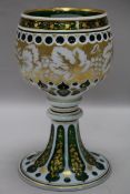 A late 19th century Bohemian white and green overlaid cut glass standing cup H24.5cm