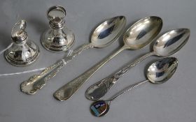 A pair of silver menu holders and four silver spoons, various