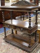 A late Victorian carved oak three tier buffet, fitted two drawers W.111cm