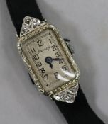 A lady's 1920's/1930's 18ct white gold and diamond set cocktail watch.