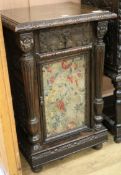 A late Victorian carved oak bedside cupboard, W.55cm