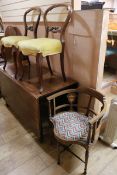 A pair of Victorian rosewood dining chairs and a tub chair