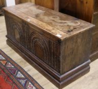 A carved oak coffer W.122cm