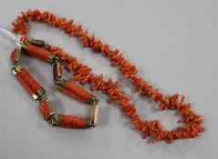 A yellow metal and coral bracelet and a coral necklace.