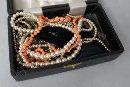 A group of costume jewellery and a coral necklace.