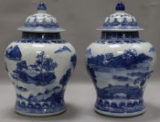 A pair of Chinese blue and white lidded vases, late 20th century, transfer printed, height 28cm