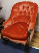 A Victorian walnut framed open armchair with salmon pink upholstery